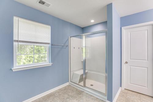 a bathroom with a glass shower stall and a window at Pet-Friendly Ladson Home 23 Mi to Charleston! in Ladson