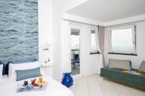 a bedroom with a bed with a tray of toys on it at La Divina Amalfi Coast in Praiano