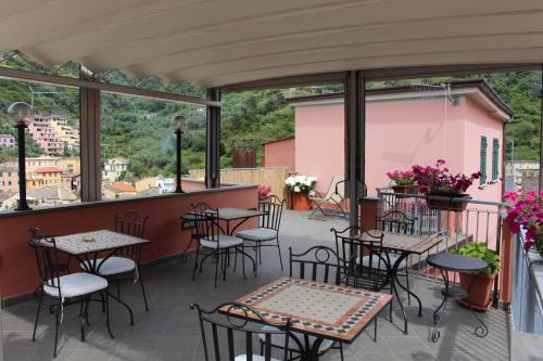 a patio with tables and chairs on a balcony at Il Timone Lerta in Monterosso al Mare