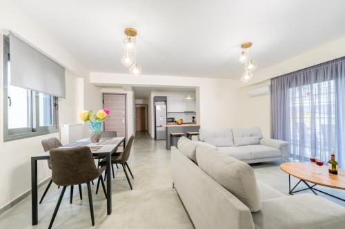 a living room with a couch and a table at IAIRA in Athens