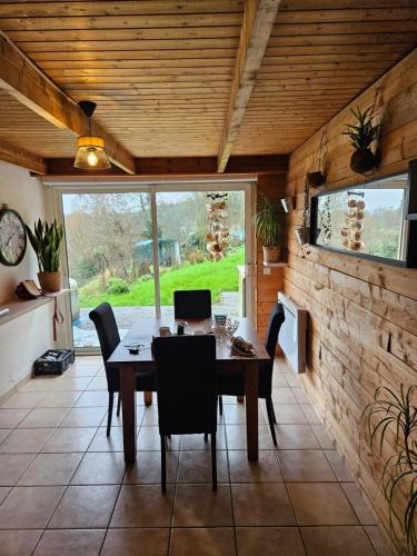 a dining room with a table and chairs at L'ECUREUIL in Loc-Envel