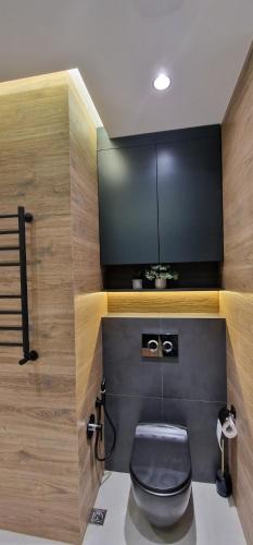 a bathroom with a black toilet in a room at Baku White City-Seaview Luxury Apartment in Baku