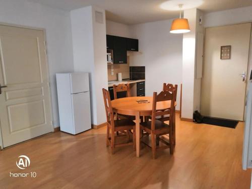 a kitchen and dining room with a table and chairs at Grand studio à la montagne in Ax-les-Thermes