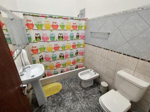a bathroom with a toilet and a sink at Cabañas Buena Vista Rosi in San Carlos de Bariloche