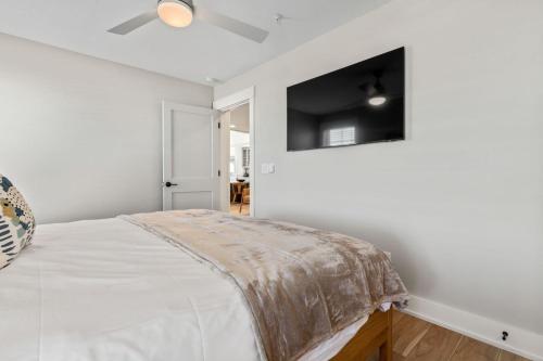 a bedroom with a bed and a flat screen tv at Island Enchantment by KEES Vacations in Kill Devil Hills