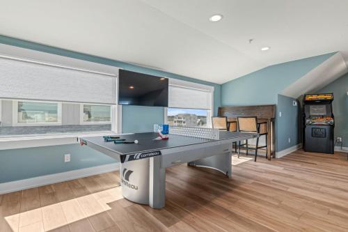 a gaming room with a ping pong table in it at Island Enchantment by KEES Vacations in Kill Devil Hills