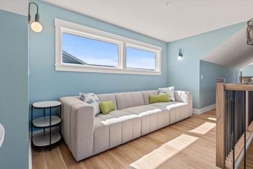 a living room with a couch and a window at Island Enchantment by KEES Vacations in Kill Devil Hills