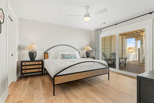 a bedroom with a bed and a table and chairs at Island Enchantment by KEES Vacations in Kill Devil Hills