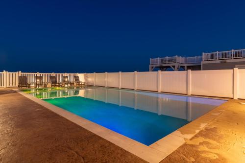 a swimming pool at night on a building at Island Enchantment by KEES Vacations in Kill Devil Hills