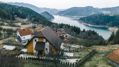 a house on a hill next to a river at Villa Montana Zaovine in Bajina Bašta