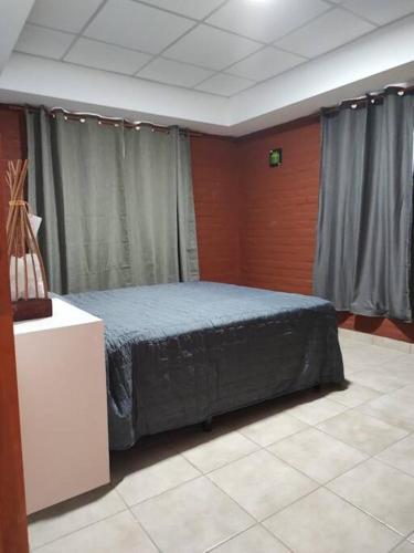 a bedroom with a bed in a room at Complejo de Cabaña con pileta CABLE A TIERRA Cabaña Blend in San Rafael