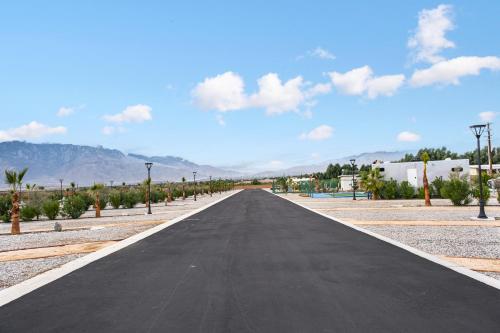 an empty road in the middle of a desert at RV71-Lot- Paradise RV Park in Desert Hot Springs