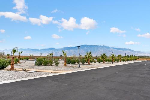 a parking lot with palm trees and a street at RV71-Lot- Paradise RV Park in Desert Hot Springs