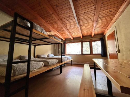 two bunk beds in a room with a wooden ceiling at Camping Noguera Pallaresa in Sort