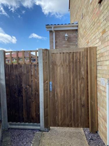 a wooden fence in front of a building at 12 The Annex in Caistor Saint Edmunds