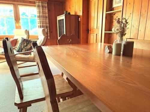 a large wooden table in a room with a kitchen at Halden 598 in Unterwasser