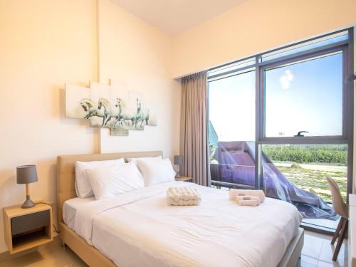 a bedroom with a bed and a large window at Luxury 1-Bedroom Hideaway In Meydan in Dubai
