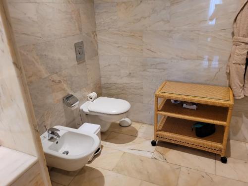 a bathroom with a toilet and a sink at Palm Oasis - Time Sharing in Las Palmas de Gran Canaria