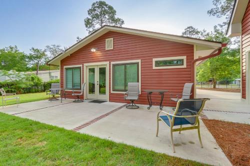 a red house with a patio and a table and chairs at Charming Bluffton Vacation Home with Yard! in Bluffton