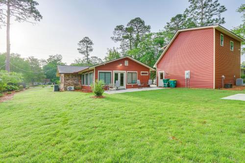 a home with a red barn and a yard at Charming Bluffton Vacation Home with Yard! in Bluffton