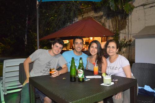 a group of people sitting at a table with beer bottles at Chanchamayo Inn Hotel in La Merced