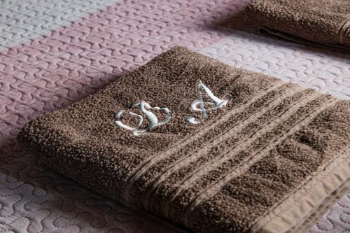 a blanket on a bed with two rings on it at Di&Ana - Alojamento Redondo in Redondo