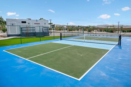 a tennis court with a tennis net on it at RV71-Lot- Paradise RV Park in Desert Hot Springs
