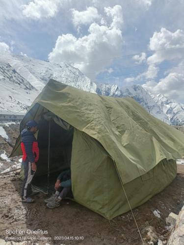 a couple of people standing inside of a tent at GarhKumoan in Kedārnāth
