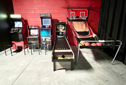 a room with two pinball machines next to a wall at The Arcade close to downtown with fenced yard in Sanford