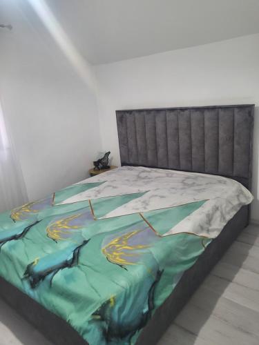 ein Bett mit einem Gemälde darauf in einem Schlafzimmer in der Unterkunft Alina apartaments in Sibiu