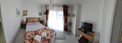 a bedroom with a bed and a flat screen tv at villa les lavandes in Saint-Alban