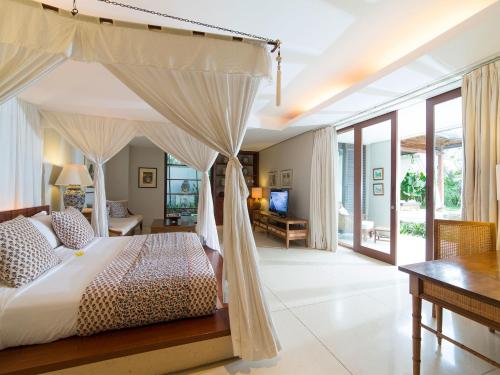 a bedroom with a bed with a canopy at Villa Lilibel by Elite Havens in Seminyak