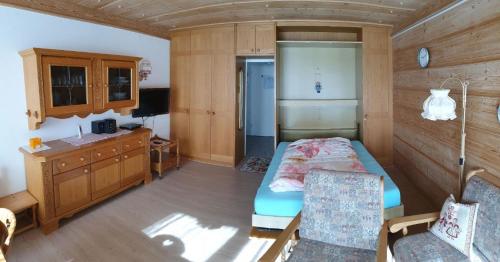 a room with a bedroom with a bed and a desk at Kleine Wohnung in Tiefenbach mit Sauna und Schwimmbad in Oberstdorf