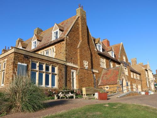 a large brick building with a bench in front of it at 5a Hideaways in Hunstanton