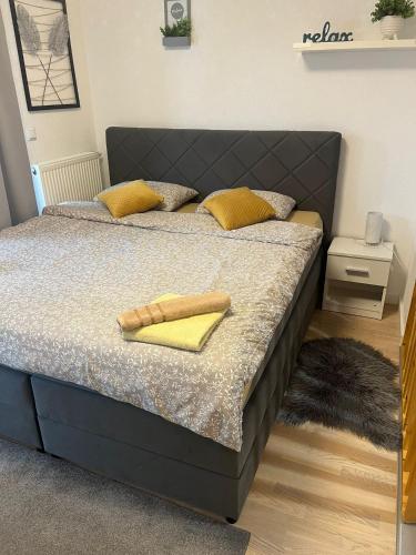 a bed with two yellow towels on it in a bedroom at Studio apartman Implex in Đakovo
