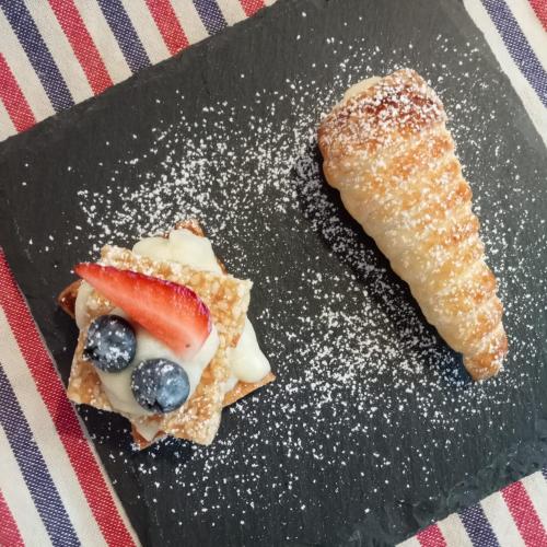 a plate of food with a pastry and a banana at SANTINO'S HOUSE in Peveragno