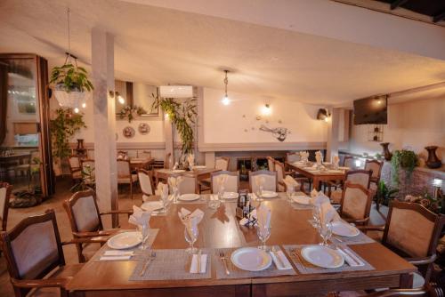 a dining room with a long table and chairs at Hotel Kiko in Bitola