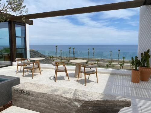 a patio with tables and chairs and a view of the ocean at SPECTACULAR APRT. IN FRONT OF THE SEA in Mojácar