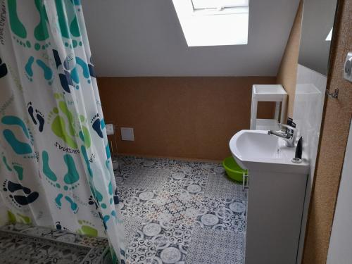 a bathroom with a shower curtain and a sink at Pokoje gościnne-Głotowo in Dobre Miasto