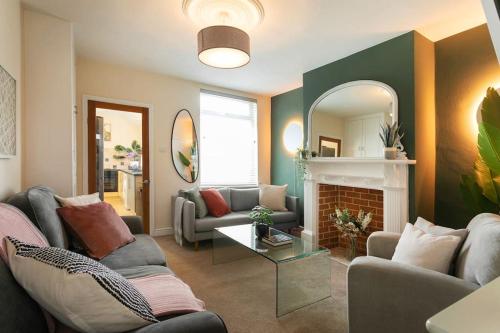 a living room with two couches and a fireplace at Stylish 4 Bed Home In Central Nottingham w/Parking in Nottingham