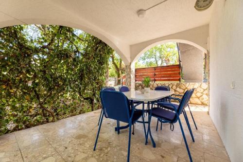 a table and chairs sitting on a patio at Ferienwohnung für 4 Personen ca 50 qm in Njivice, Kvarner Bucht Krk in Njivice