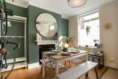 a living room with a table and a mirror at Stylish 4 Bed Home In Central Nottingham w/Parking in Nottingham