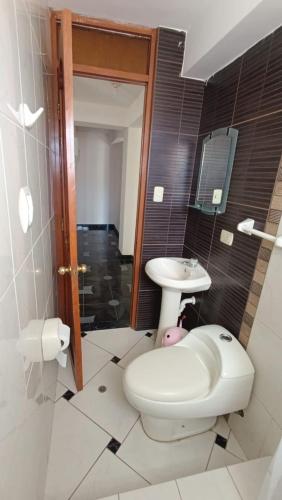 a bathroom with a toilet and a sink at WaskarWasi in Cusco