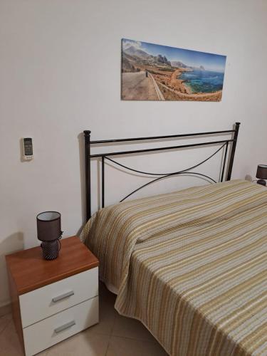 um quarto com uma cama e uma fotografia na parede em la casa del nonno em Trapani