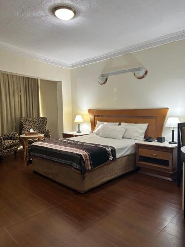 a bedroom with a bed and a desk and a chair at Furnished Deluxe Private Studio Apartments near Union Metro Station in Dubai