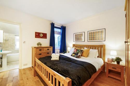 a bedroom with a large bed and a bathroom at Harry Potter Experience - 3 Bed House In Watford in Watford