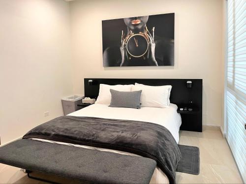 a bedroom with a bed and a picture of a man at Luxury Beachfront Condo in Rosarito Pool & Jacuzzi in Rosarito