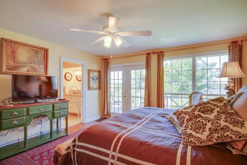 a bedroom with a bed and a flat screen tv at Exquisite Lake Charles Gem - Waterfront Views in Lake Charles