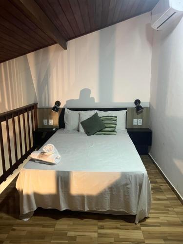 a bedroom with a large bed in a room at Pipa Golfinhos Pousada in Pipa