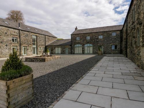 an external view of the courtyard of a stone building at Rowan Cottage in Ulverston